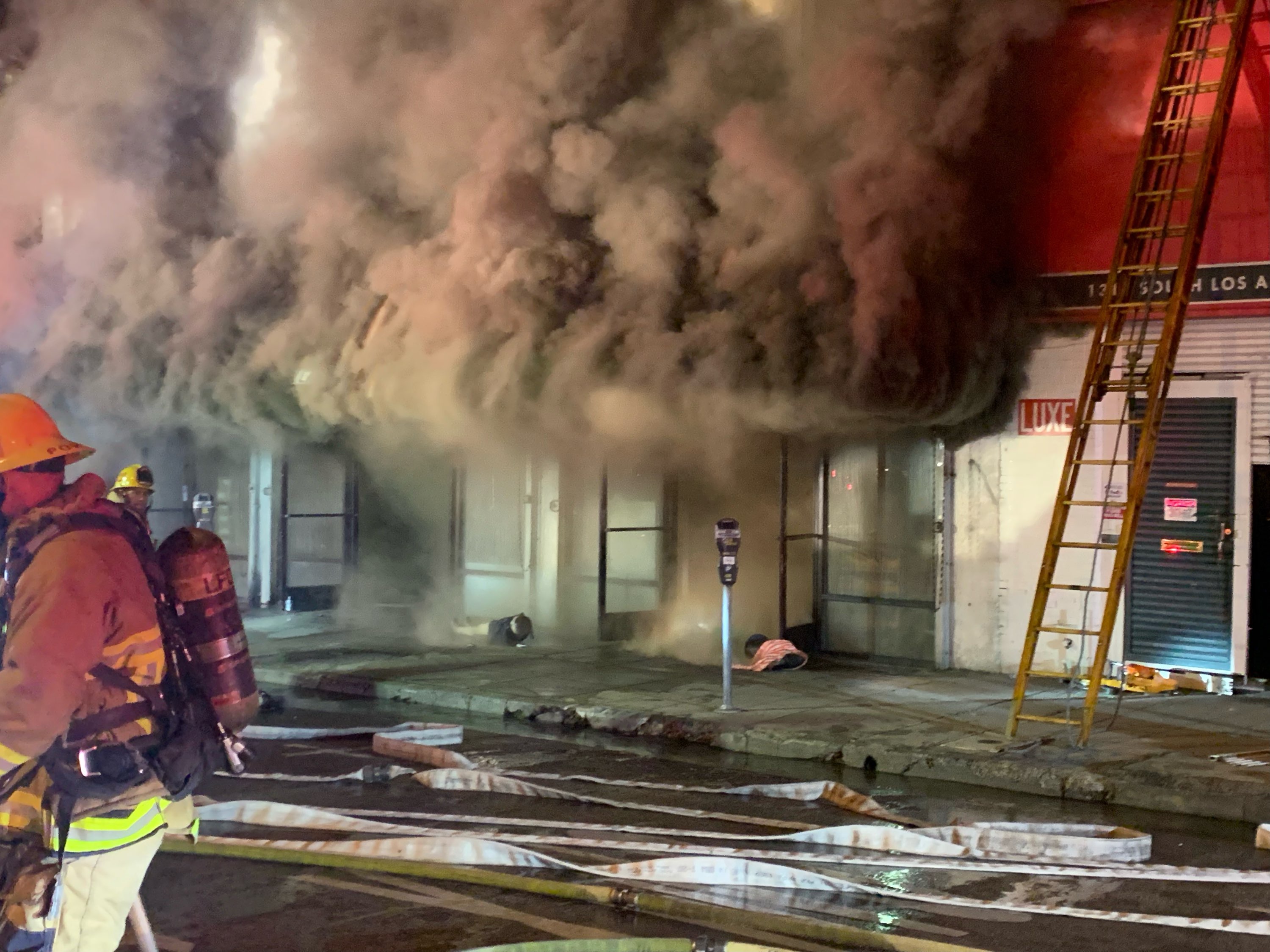 smoke seen billowing out from top of commercial row unit