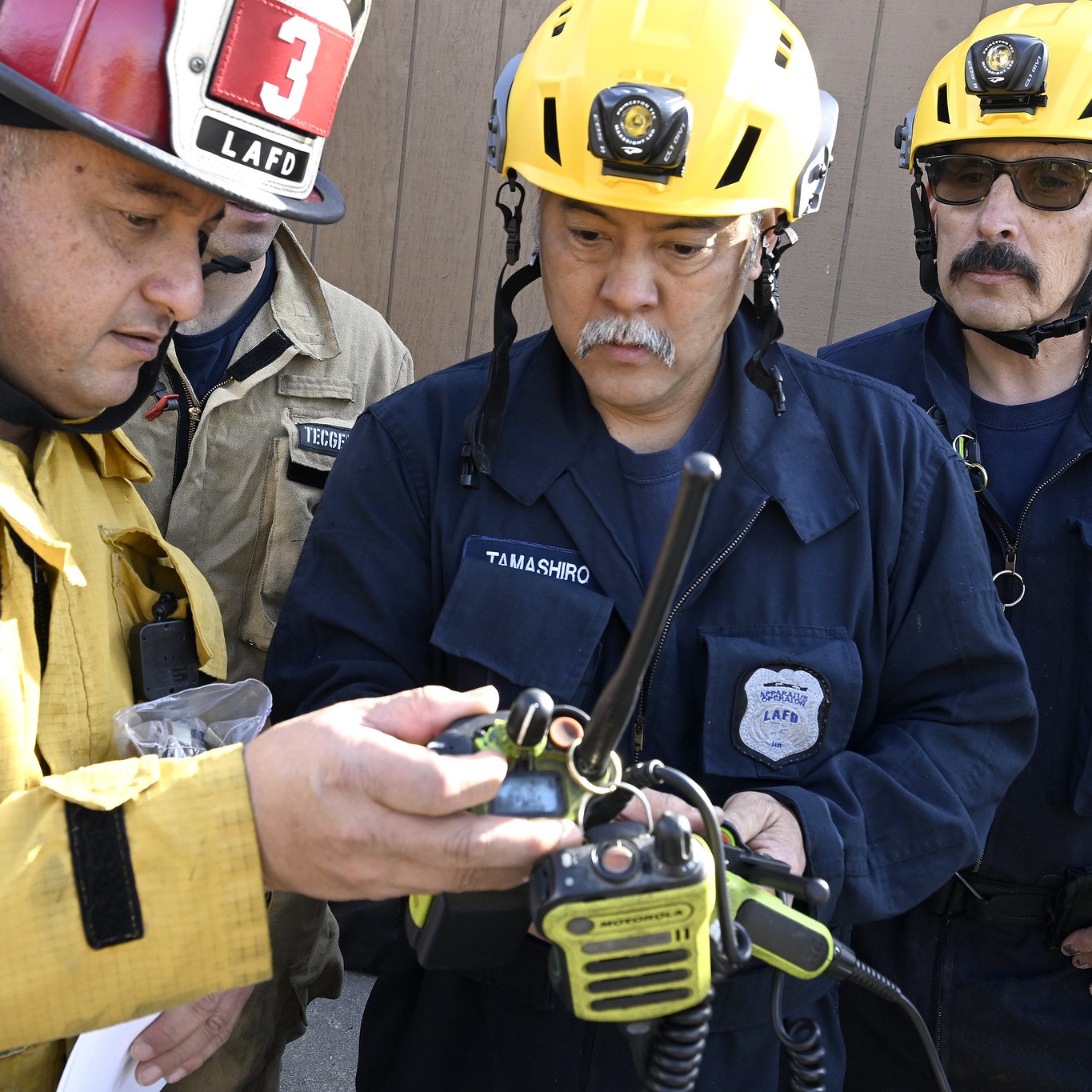Firefighters working with handheld radios